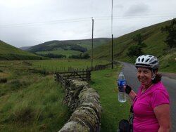 All smiles, 9 miles of climbing left.JPG