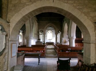 250602-1883 Duntisbourne Abbots St Peter nave thro  late Norman tower arch from W.JPG